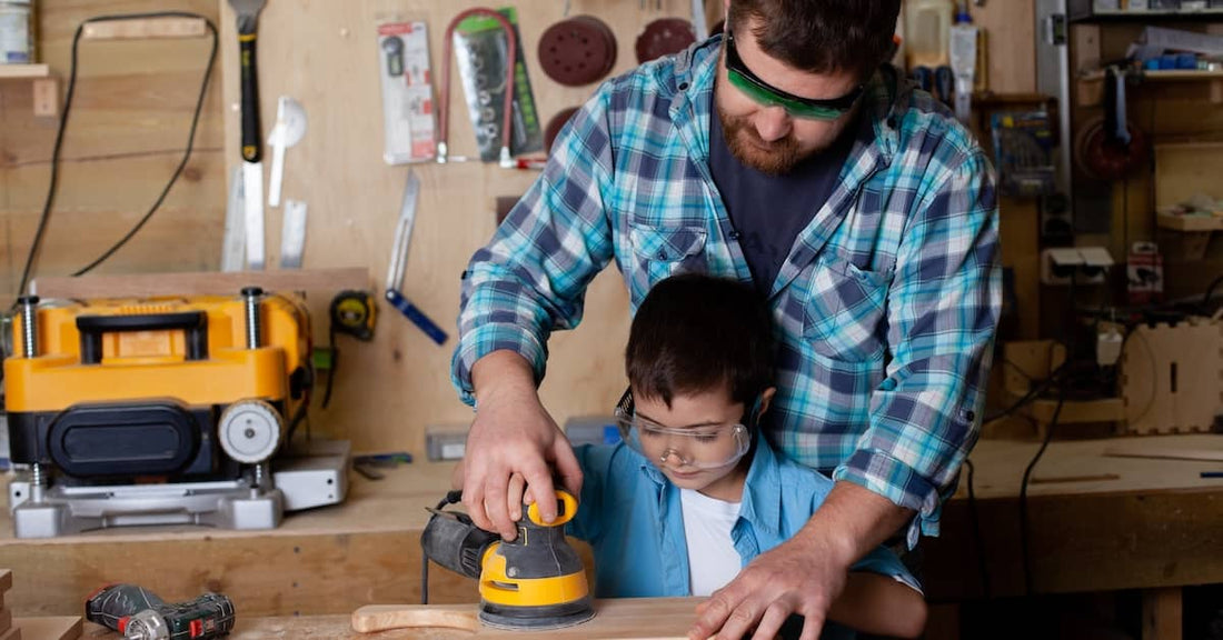 Father and son work in garage.